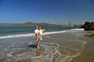 Bay Area beach wedding, couple in water with golden gate bridge background