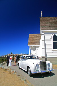wedding ceremony package options, limo in front of church with couple